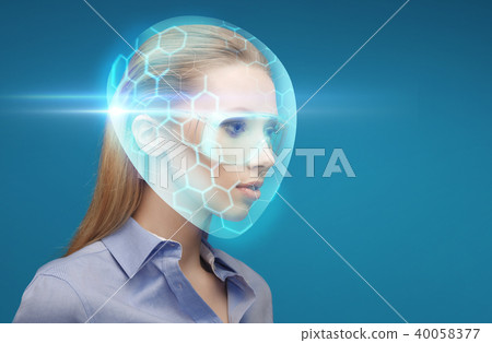woman in virtual helmet and goggles over blue 40058377
