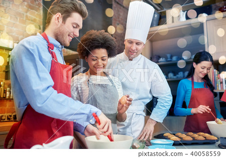 happy friends and chef cook baking in kitchen happy friends and chef cook baking in kitchen 40058559