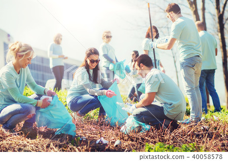 volunteers with garbage bags cleaning park area volunteers with garbage bags cleaning park area 40058578