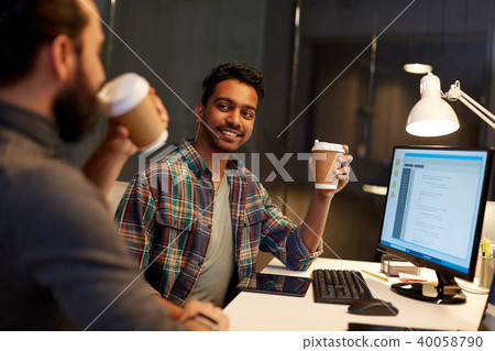 creative team drinking coffee at night office 40058790