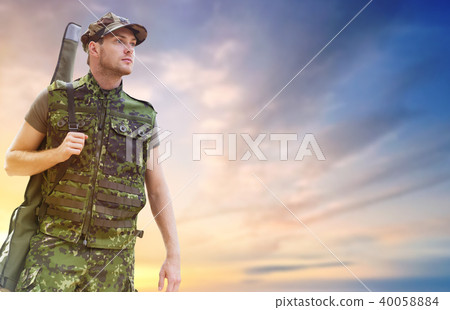 young soldier or hunter with gun over sky young soldier or hunter with gun over sky 40058884