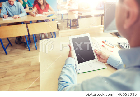 students and teacher with tablet pc at school 40059089