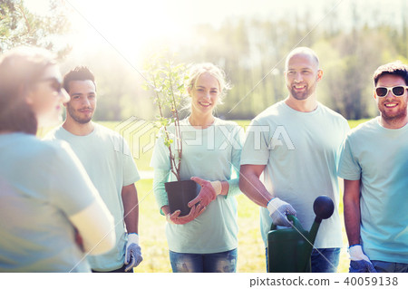 group of volunteers with tree seedling in park group of volunteers with tree seedling in park 40059138