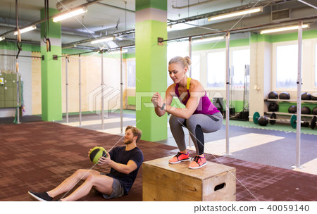 woman and man with medicine ball exercising in gym 40059140