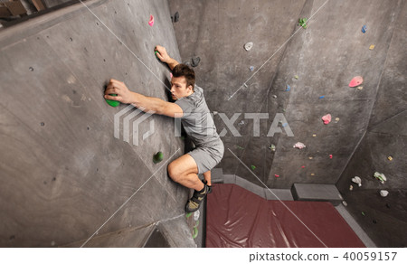 young man exercising at indoor climbing gym 40059157
