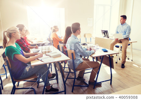 group of students and teacher with papers or tests group of students and teacher with papers or tests 40059308