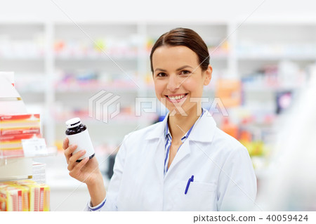happy female apothecary with drug at pharmacy happy female apothecary with drug at pharmacy 40059424