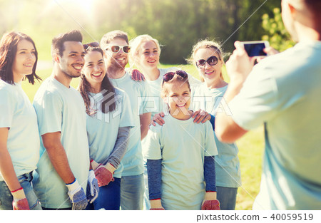 group of volunteers taking picture by smartphone group of volunteers taking picture by smartphone 40059519