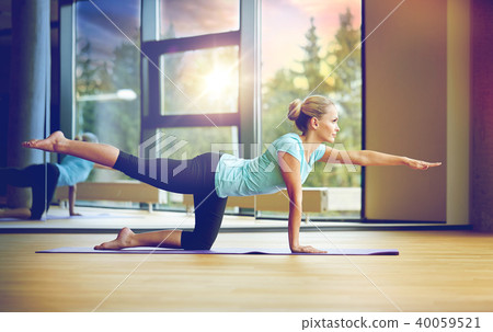 smiling woman doing exercise in gym smiling woman doing exercise in gym 40059521
