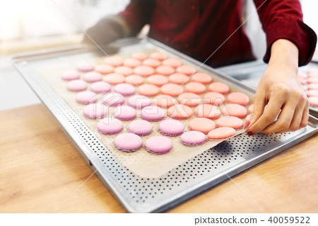 chef with macarons on oven tray at confectionery chef with macarons on oven tray at confectionery 40059522