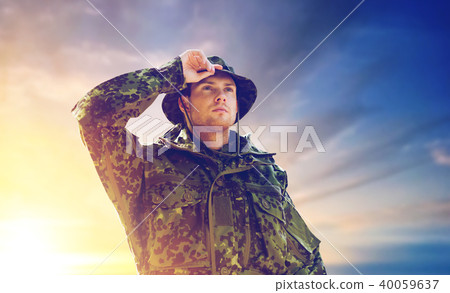 young soldier in military uniform over sky 40059637