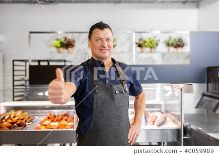 seafood seller at fish shop showing thumbs up 40059989