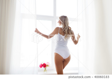 woman in underwear at window in morning 40060183