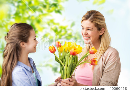 happy daughter giving flowers to mother happy daughter giving flowers to mother 40060438