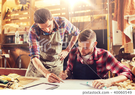 workmen with tablet pc and blueprint at workshop workmen with tablet pc and blueprint at workshop 40060549