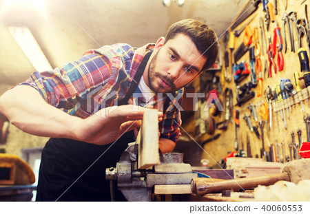 carpenter working with plane and wood at workshop carpenter working with plane and wood at workshop 40060553