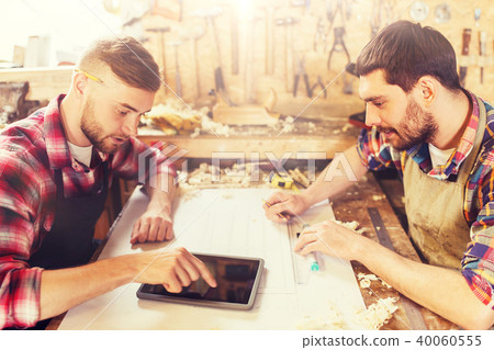 workmen with tablet pc and blueprint at workshop workmen with tablet pc and blueprint at workshop 40060555