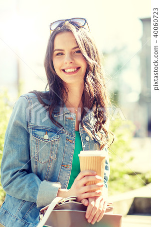 happy young woman drinking coffee on city street happy young woman drinking coffee on city street 40060723
