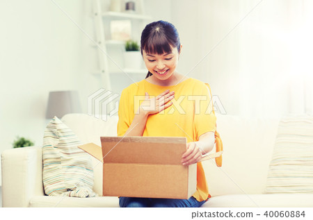 happy asian young woman with parcel box at home happy asian young woman with parcel box at home 40060884
