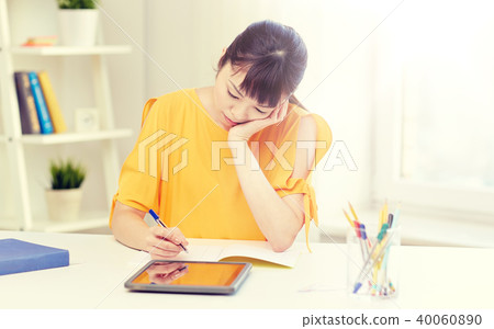 bored asian woman student with tablet pc at home bored asian woman student with tablet pc at home 40060890