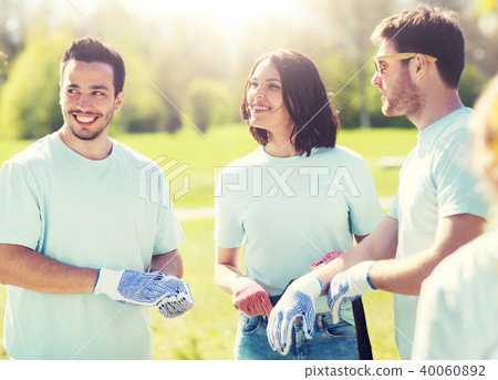 group of volunteers planting tree in park 40060892