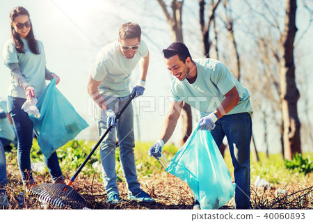 volunteers with garbage bags cleaning park area volunteers with garbage bags cleaning park area 40060893