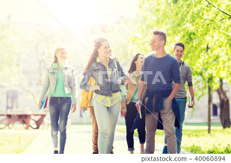 group of happy teenage students walking outdoors group of happy teenage students walking outdoors 40060894