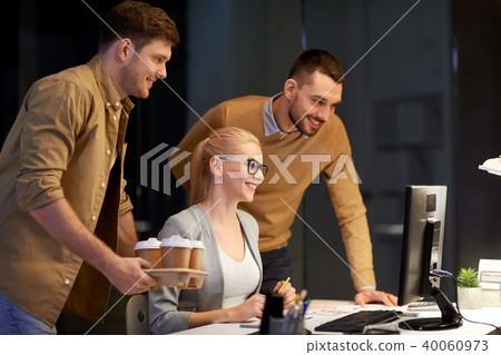 business team with computer working late at office 40060973