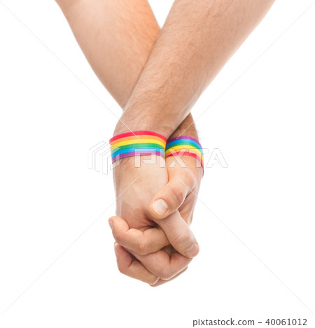 hands of couple with gay pride rainbow wristbands 40061012