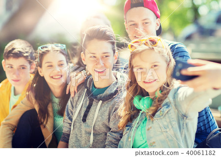 happy teenage students taking selfie by smartphone happy teenage students taking selfie by smartphone 40061182