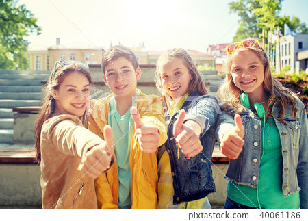 happy students or friends showing thumbs up 40061186