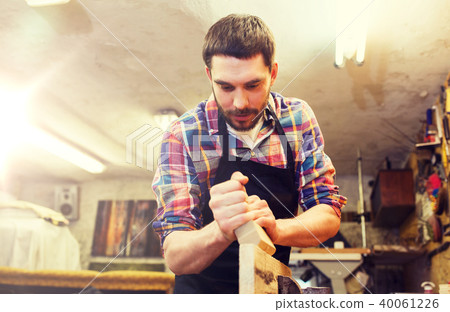 carpenter working with plane and wood at workshop carpenter working with plane and wood at workshop 40061226