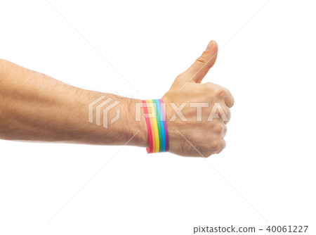 hand with gay pride rainbow wristband shows thumb 40061227