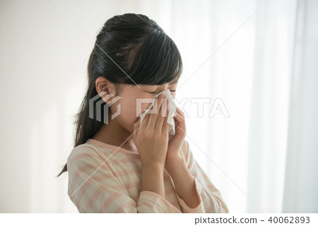 Elementary school girl blowing nose Elementary school girl blowing nose 40062893