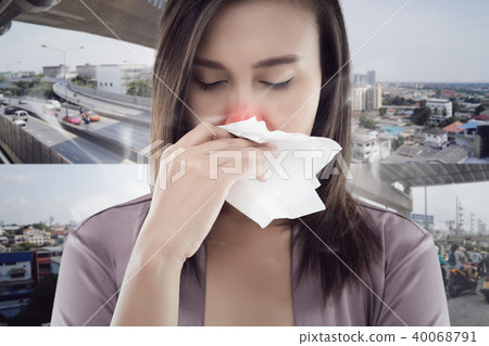 Woman smelling toxic smoke on city background 40068791
