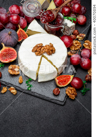 Camembert cheese and walnuts on stone serving board Camembert cheese and walnuts on stone serving board 40070894