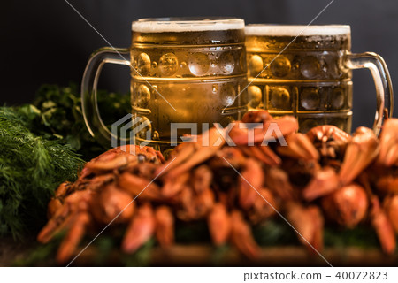 Boiled crayfish with beer on wooden background 40072823