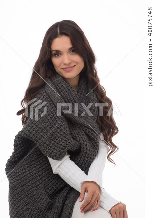Portrait of brunette woman wearing gray cardigan Portrait of brunette woman wearing gray cardigan 40075748