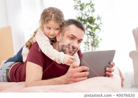 Overjoyed girl having fun with her father 40076020