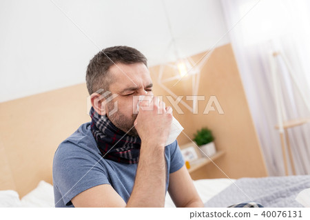 Sick man blowing his nose Sick man blowing his nose 40076131