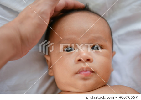 Newborn Concept. Mother and child on a white bed. Mom and baby b 40076557