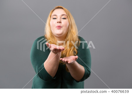Pleasant cheerful woman sending an air kiss 40076639