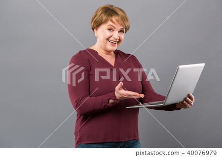 Joyful happy woman showing her laptop 40076979