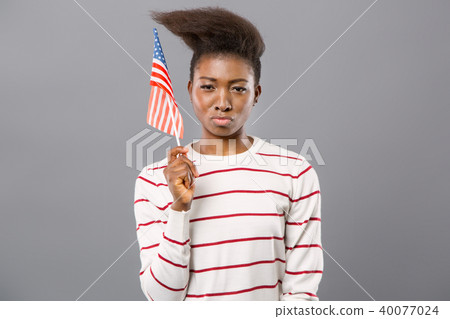 Confident young woman showing American flag 40077024