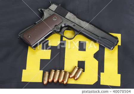 colt government m1911 with ammo on fbi uniform 40078504