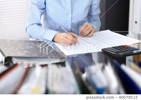 Female bookkeeper or financial inspector making report, calculating or checking balance. Interna Female bookkeeper or financial inspector making report, calculating or checking balance. Interna 40079515