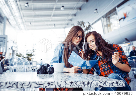 girls in cafe look menu.Art processing and retouching photos spe 40079933