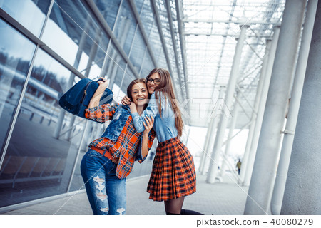 Girls having fun and happy when they met at the airport.Art proc 40080279