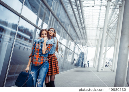 Girls having fun and happy when they met at the airport.Art proc 40080280