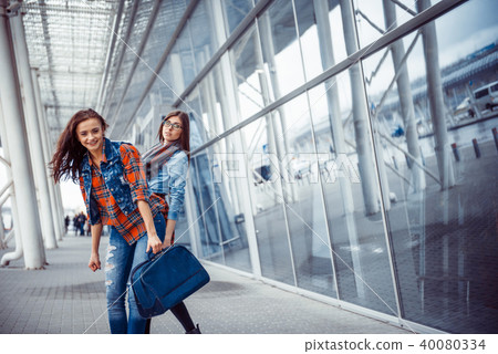 Girls having fun and happy when they met at the airport.Art proc 40080334